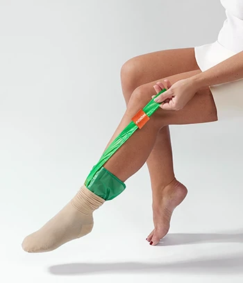 a female model using arion dactyna donning aid for wearing compression stocking