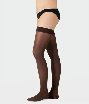 Side view of a female model legs wearing black color juzo inspiration compression stocking