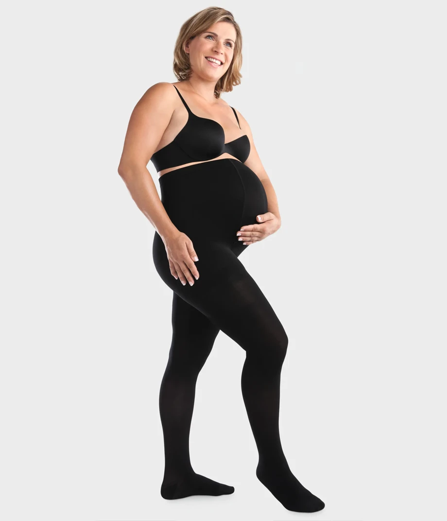 Side view of pregnant model standing and waring a Black color Maternity Compression Stockings
