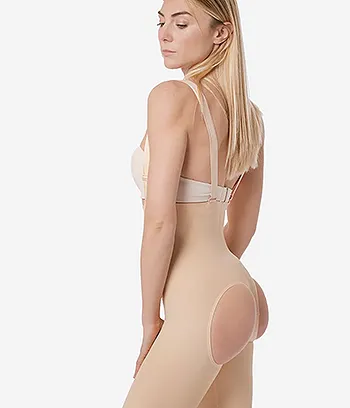 Side view of female model wearing a beige color BBL implant faja compression garment.